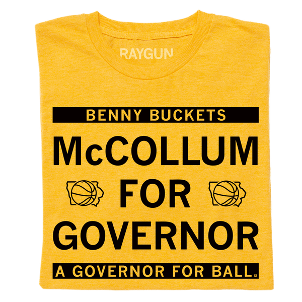 A folded heather gold shirt with black ink text that reads 