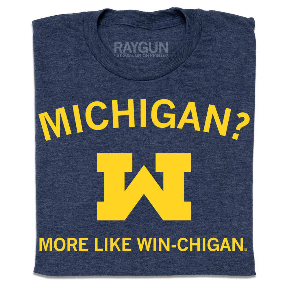 A folded heather denim shirt with gold ink that reads "Michigan? More like win-chigan" with a large W in the center.