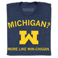 A folded heather denim shirt with gold ink that reads "Michigan? More like win-chigan" with a large W in the center.