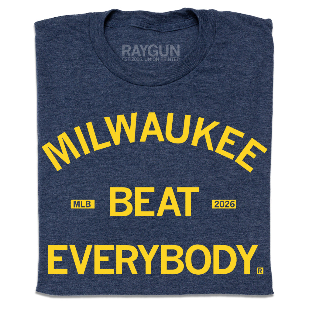 Folded heather navy t-shirt with bright yellow text that says, "Milwaukee Beat Everybody."