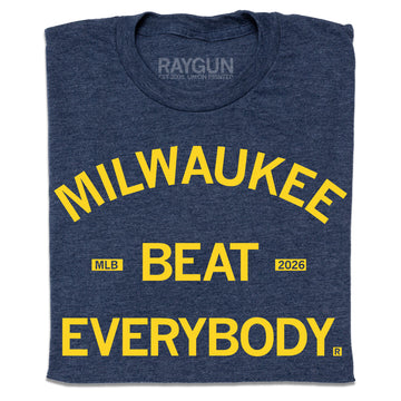 Folded heather navy t-shirt with bright yellow text that says, "Milwaukee Beat Everybody."