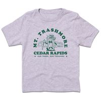 Heather grey youth size t-shirt with green ink that reads "Mt. Trashmore, Cedar Rapids. Our trash, our treasure" framing an image of a cartoon trashcan going for a hike with Mt. Trashmore in the background.