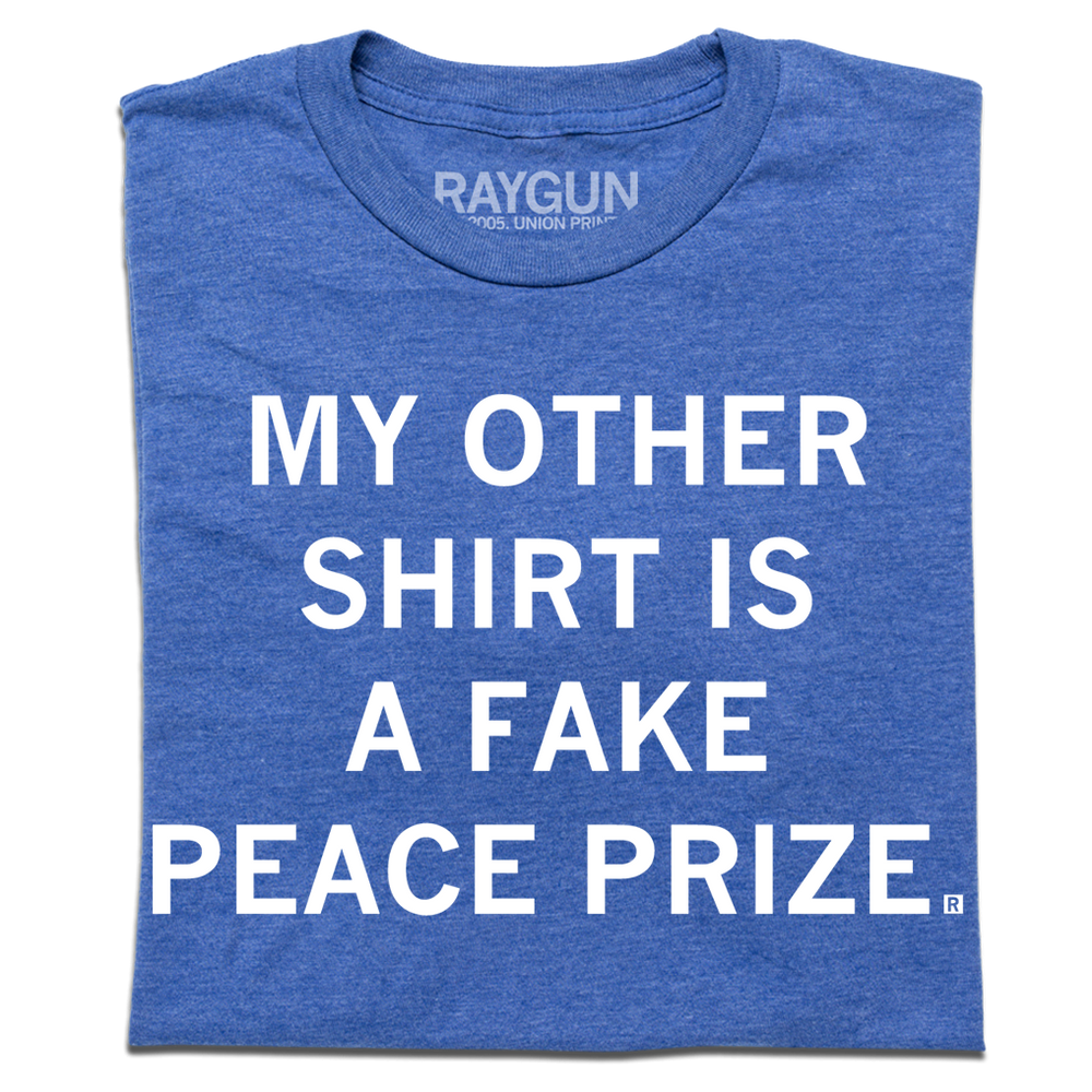 A heather royal t-shirt with centered white ink text that reads "My Other Shirt is a Fake Peace Prize"