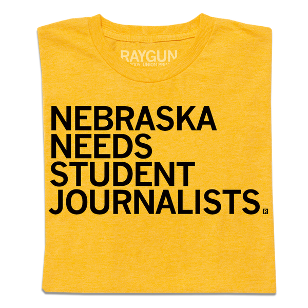 A folded heather gold t-shirt with left aligned black in text that reads 