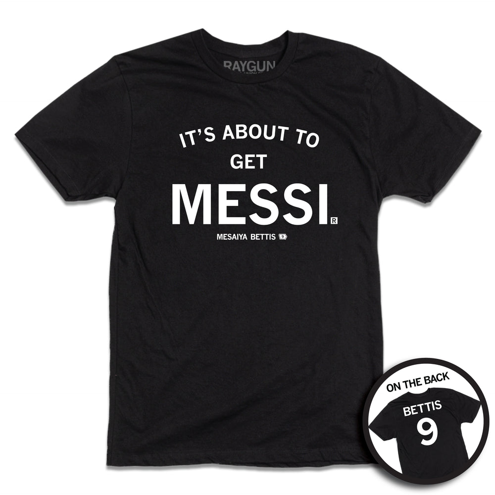 short sleeve black t-shirt with centered white ink print that reads "It's About to Get Messi" with smaller text below that says, "Mesaiya Bettis" beside a small outline of Iowa with the number 9 in it. A second picture in a small circle frame is in the bottom right corner, showing the back print. The back is laid out like a jersey with "Bettis" printed across the shoulders above the number 9.