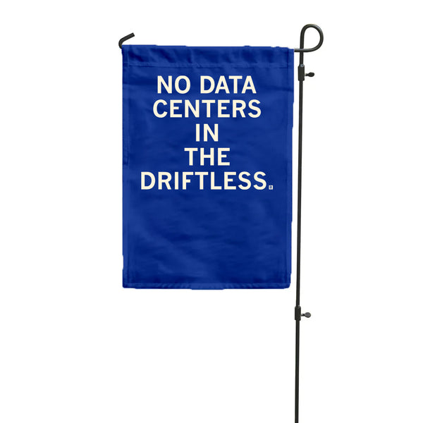 A royal blue garden flag hanging vertically from a flag pole with white ink text that says, 