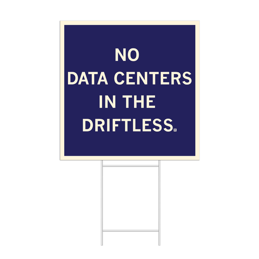 A dark blue square yard sign with off-white border and text that reads "No data centers in The Driftless."