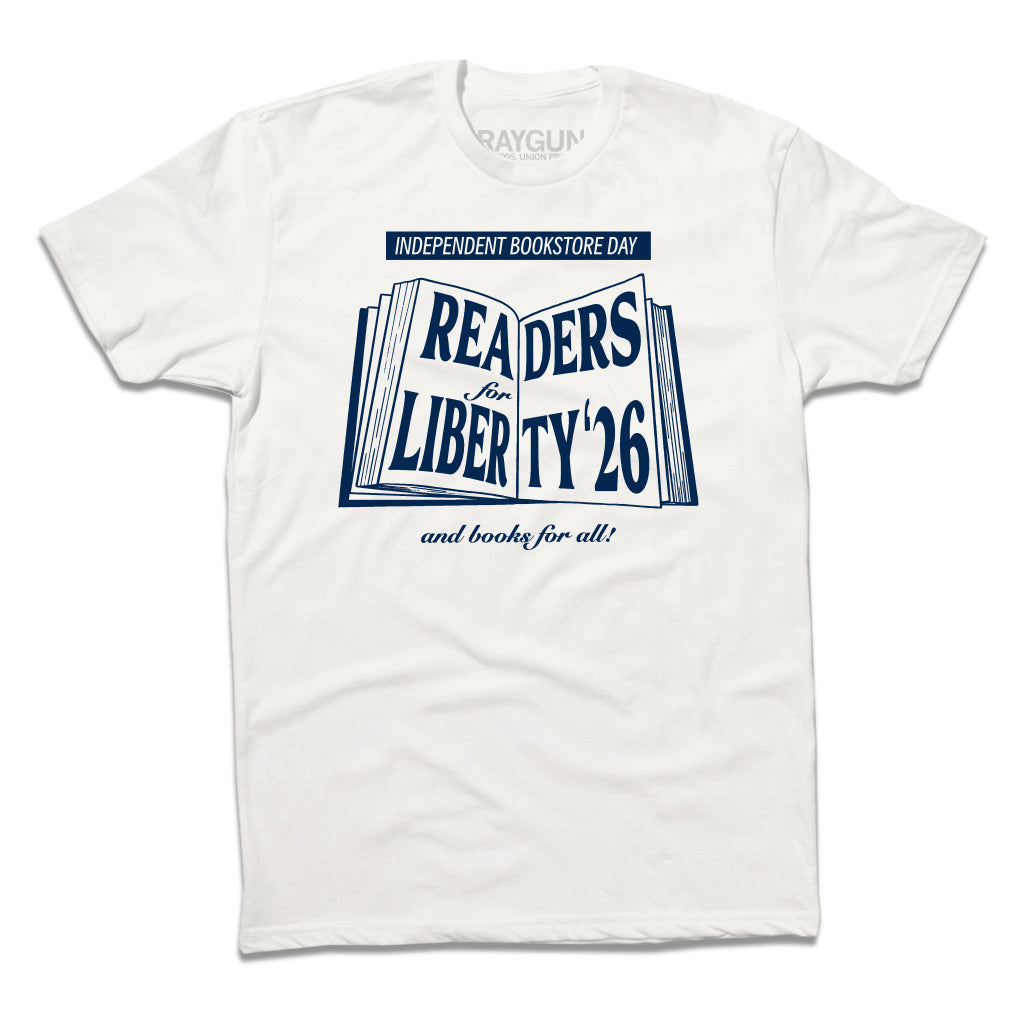 White Independent Bookstore Day t-shirt featuring an open book graphic with the text: Readers for Liberty 26 and books for all!.