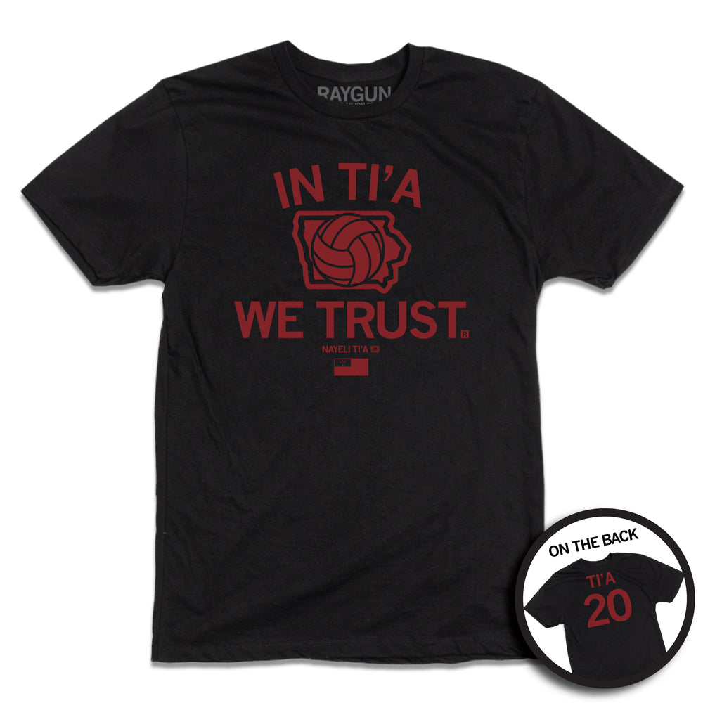 Short-sleeve black t-shirt with red ink print depicting Iowa in the center with a volleyball taking up most of the state. Text above and below Iowa says, "IN TI'A WE TRUST" with "NAYELI TI'A" in smaller  print below. Beside her name is a tiny Iowa with the number 20 in it and at the bottom of the print is the flag for Samoa. A circular image in the bottom right shows the back print. The back is laid out like a jersey with "TI'A" printed above 20.