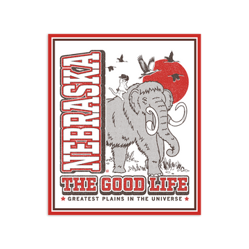 Die-cut vinyl Nebraska sticker featuring a woolly mammoth with a cowboy cat on its back, a red sun, birds, and the text Nebraska: The Good Life, Greatest Plains in the Universe.
