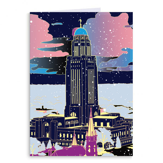 Stylized RAYGUN illustration of the Nebraska Capitol at night, depicted with bold outlines and a vibrant pink, blue, and black color palette.