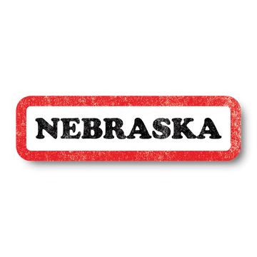 A vintage style white rectangle sticker with a faded red border and faded black text that says, "NEBRASKA"