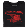 A folded black t-shirt with brite red ink and curved text that says, "Nebrasketball" above an outline of Nebraska with a basketball going through a hoop.