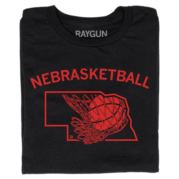 A folded black t-shirt with brite red ink and curved text that says, "Nebrasketball" above an outline of Nebraska with a basketball going through a hoop.
