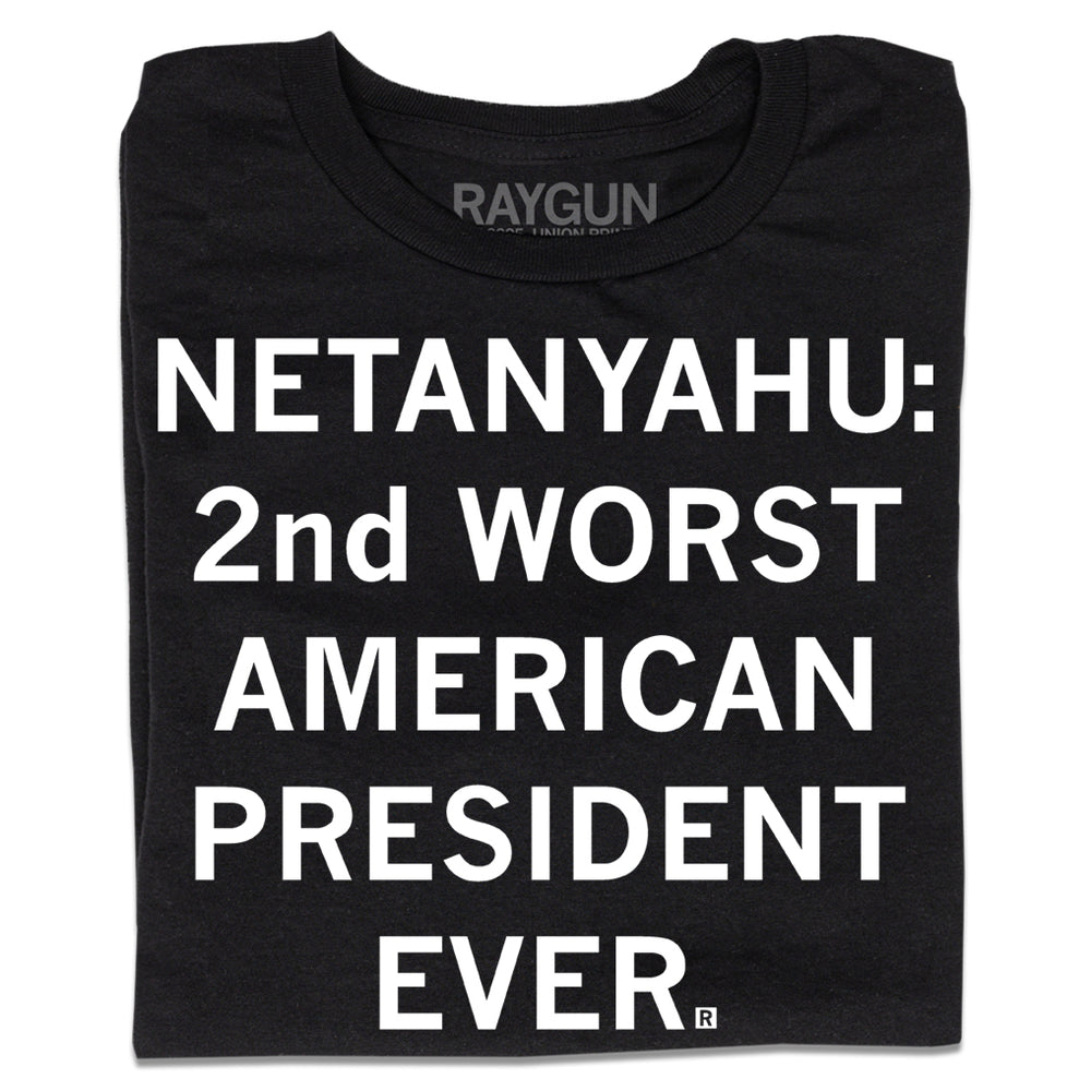 A folded black t-shirt with centered white ink text that says, "Netanyahu: 2nd Worst American President Ever."