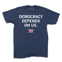 A heather navy t-shirt with centered white ink text that reads "Democracy Depends On Us" above the No Kings logo with a red x crossing out a white crown.
