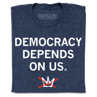A folded heather navy t-shirt with centered white ink text that reads "Democracy Depends On Us" above the No Kings logo.