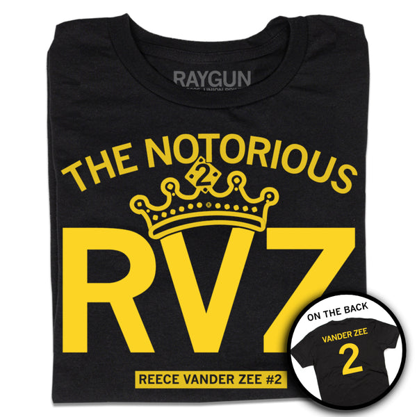 A folded black t-shirt with yellow ink text that says, 