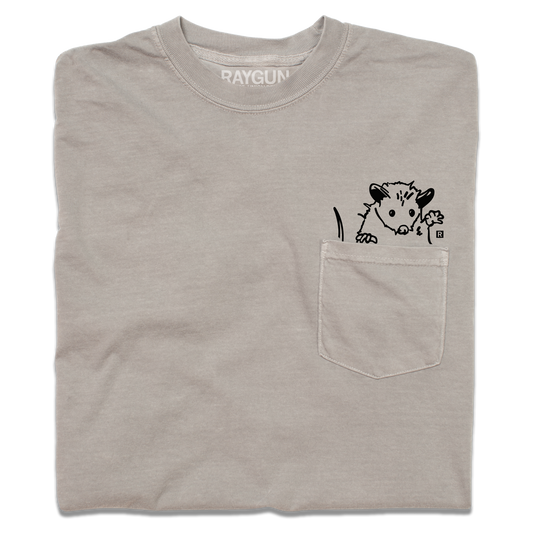 Taupe heavyweight cotton pocket t-shirt featuring a black line-drawing of an opossum peeking out of the pocket.