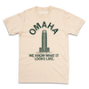 Cream t-shirt featuring a graphic of the WoodmenLife building with the text OMAHA arched above and WE KNOW WHAT IT LOOKS LIKE. below.