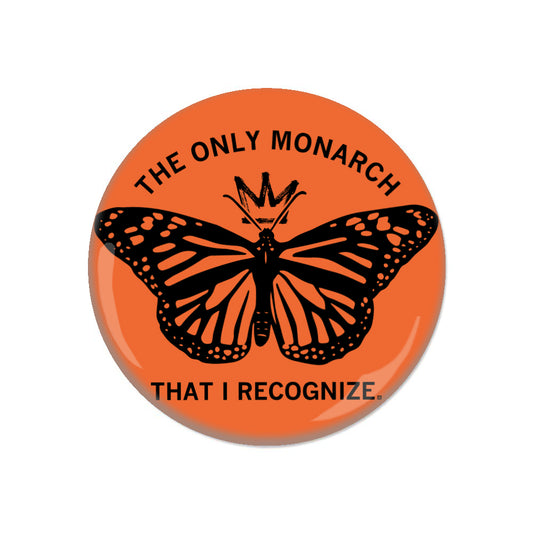 Orange RAYGUN metal button featuring a monarch butterfly, a crown, and the text THE ONLY MONARCH THAT I RECOGNIZE.