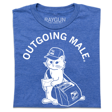 A folded heather blue short sleeve t-shirt with curved white text near the top that says, "OUTGOING MALE" above an illustration of a cat dressed as a mail carrier with a mail back over his shoulder and a letter in hand.