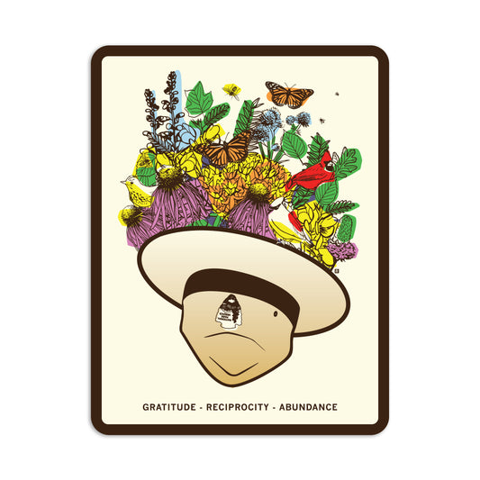 An illustration of a face wearing a wide-brimmed hat overflowing with colorful flowers, birds, and butterflies, with the text GRATITUDE - RECIPROCITY - ABUNDANCE below on this RAYGUN vinyl sticker.