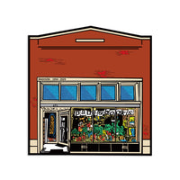 Die-cut sticker illustrating the storefront of Paul's Books in Madison, Wisconsin with plants and books seen in the shop windows.