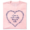 A light pink RAYGUN t-shirt featuring a dark blue floral heart outline surrounding the text Love is such a silly thing to hate.