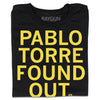 Folded black t-shirt with all caps yellow text that says, "Pablo Torre found out."