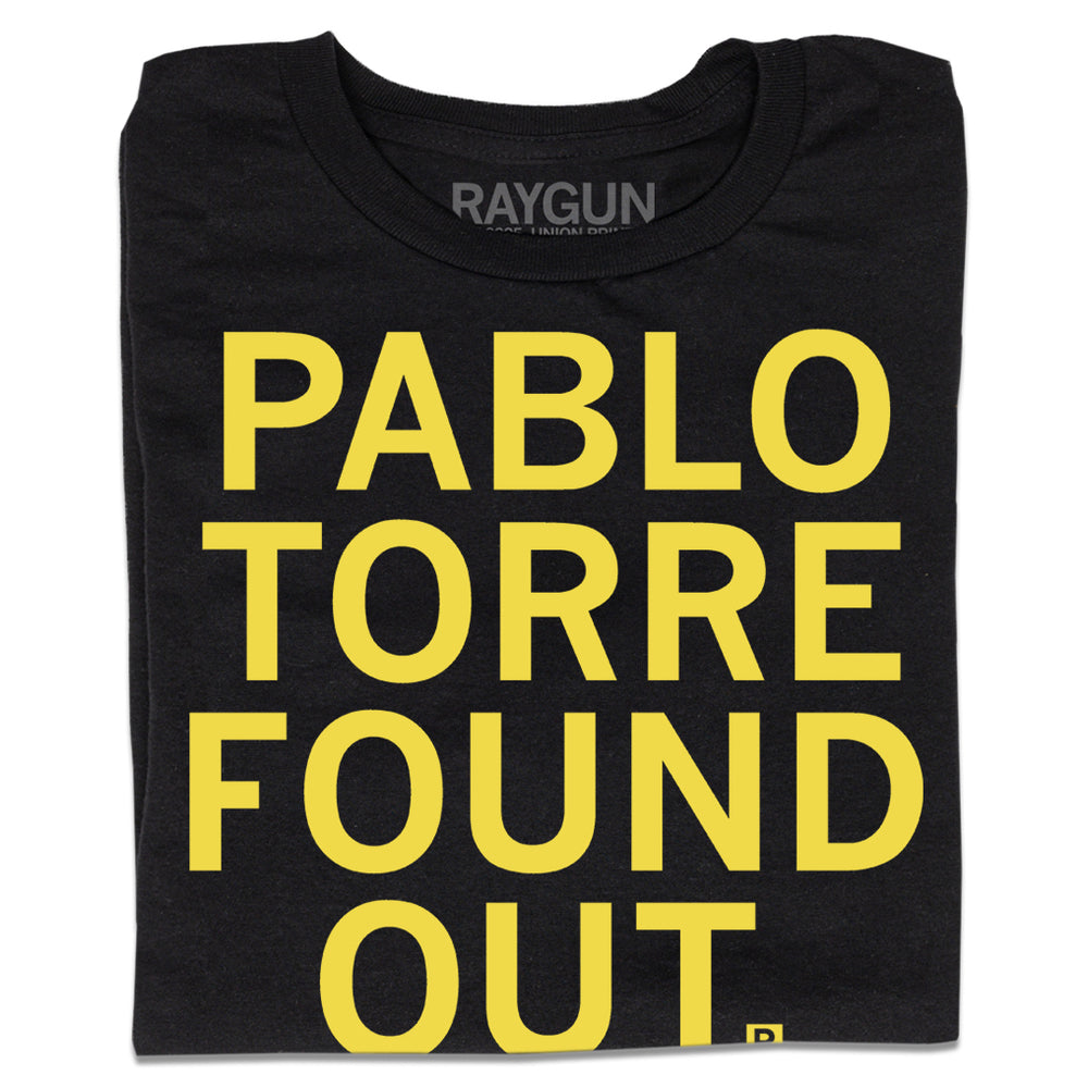 Folded black t-shirt with all caps yellow text that says, "Pablo Torre found out."