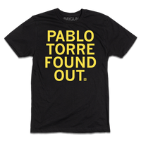 A short-sleeve black tee with centered yellow ink text that reads "PABLO TORRE FOUND OUT."