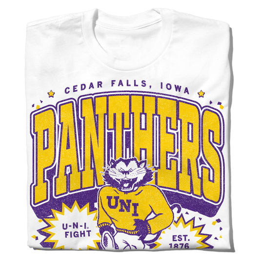 White t-shirt with a purple and yellow officially licensed graphic of a cartoon panther wearing a UNI sweater, with text reading Cedar Falls, Iowa, Panthers, U-N-I Fight, and Est. 1876.