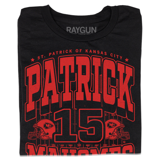 A folded black shirt with bright red ink that reads "Saint Patrick of Kansas City. Patrick Mahomes #15. There's No Place Like Mahomes" over an illustration of a football field with a football helmet to either side.
