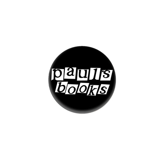 A black circular logo for Paul’s Book Store featuring the text pauls books in white letters styled like cut-out newspaper clippings.