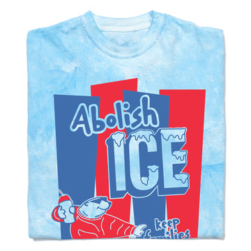 A folded Blue Colorblast T-shirt with royal blue and red ink hat reads "Abolish ICE. keep families together" with a polar bear holding a slushie.