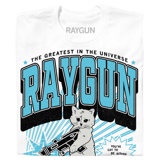 White RAYGUN t-shirt featuring a kitten holding a ray gun with the text THE GREATEST IN THE UNIVERSE and YOUVE CAT TO BE KITTEN.