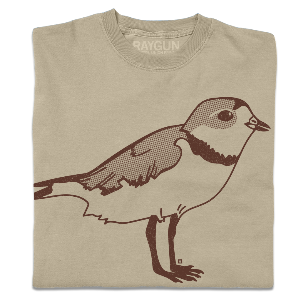 A folded khaki crewneck t-shirt with a brown ink illustration of a plover.