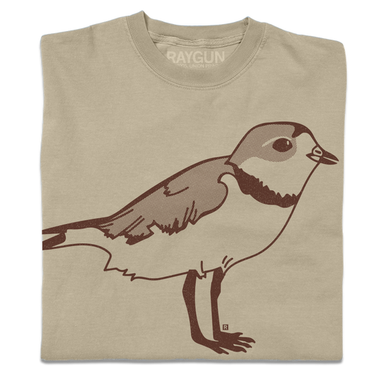 A folded khaki crewneck t-shirt with a brown ink illustration of a plover.