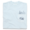 A folded light blue pocket t-shirt with navy ink. An illustration of the Chicago skyline is printed above the pocket with the Cloud Gate statue printed on the pocket.