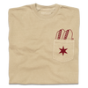 A folded beige pocket tee with dark red print of two hotdogs above the pocket and a Chicago flag star on the pocket.
