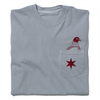 Folded grey pocket tee with dark red print. A Chicago star is printed on the pocket with an illustration of a pigeon appearing out of the pocket.