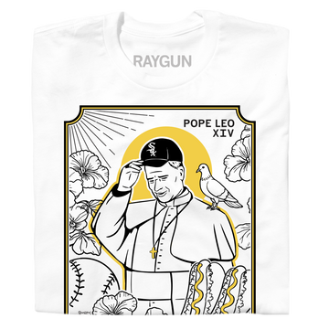 A folded white shirt with gold and black ink depicting Pope Leo wearing a White Sox hat with a pigeon on his shoulder. He's surrounding by Chicago style hotdogs, baseballs, and flowers. Black text in the top right corner says, "POPE LEO XIV" and at the bottom reads "GOD'S FAVORITE SOX FAN."