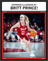 Nebraska basketball player Britt Prince dribbling a basketball on a court while wearing a white T-shirt, with text above reading APPROVED & LICENSED BY BRITT PRINCE!.