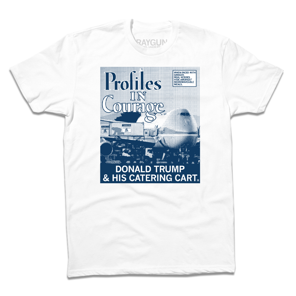 A short sleeve white t-shirt with a picture printed as a gradient with navy ink. The image is of a plane landed at an airport loading Donald Trump hiding in a food cart into the plane. A white square with a blue outline and blue text in the top right reads "WHEN FACED WITH DANGER, REAL HEROES HIDE AMONGST MICROWAVEABLE MEALS." Large text in the top left says, "Profiles In Courage" and smaller white font at the bottom of the print reads "DONALD TRUMP & HIS CATERING CART."