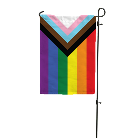 Progress Pride flag hanging on a metal garden pole.
