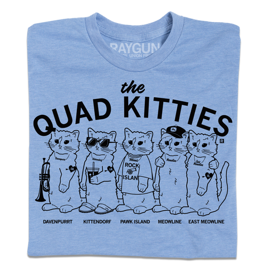 Light heather blue shirt with black ink that reads "The Quad Kitties: Davenpurrt, Kittendorf, Pawk Island, Meowline, East Meowline" with illustrations of five differently dressed cats in a line.