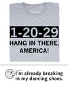 A grey, union-made T-shirt with the text 1-20-29 HANG IN THERE, AMERICA! printed in black.