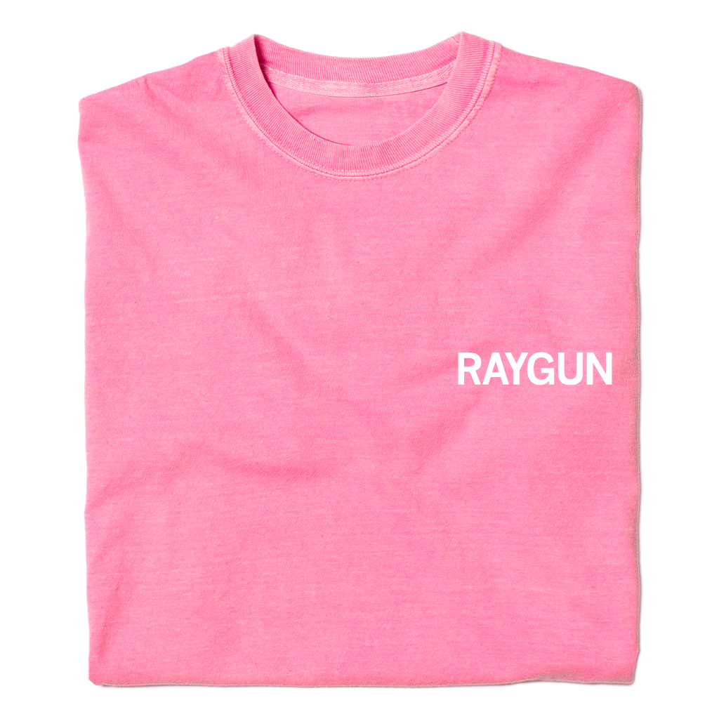 A folded bright pink t-shirt with "RAYGUN" printed over the left side of the chest.