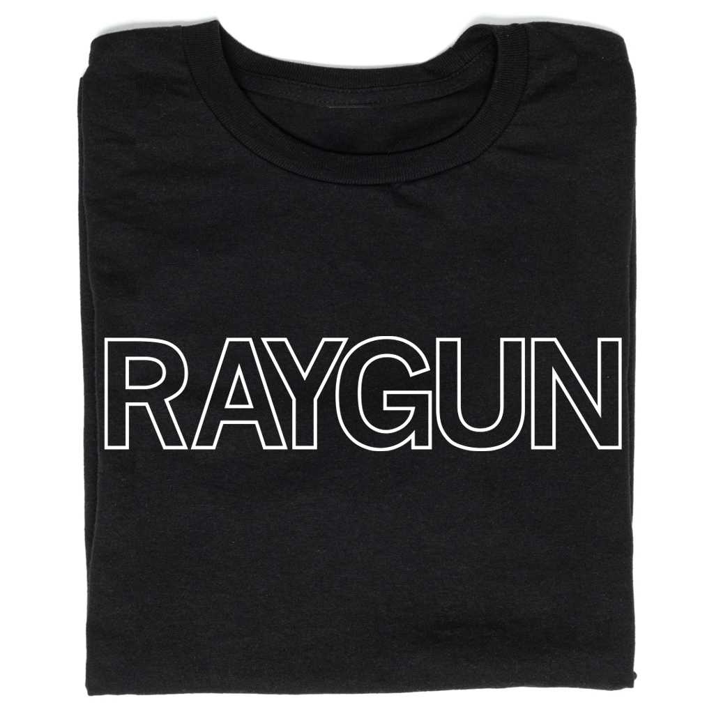 A folded black t-shirt with white outlined text that says, "RAYGUN" across the chest.